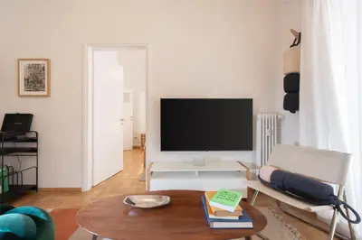a living room with a television and a table at 2BR Earthen Echoes Athens Core in Athens