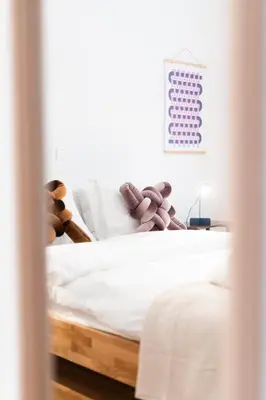 a bedroom with a white bed with teddy bears on it at 2BR Earthen Echoes Athens Core in Athens