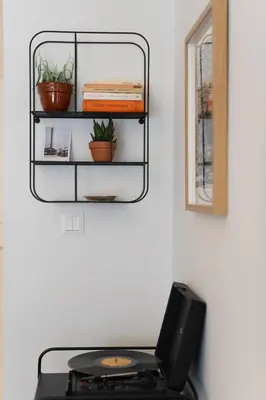 a shelf over a stove with plants and books at 2BR Earthen Echoes Athens Core in Athens
