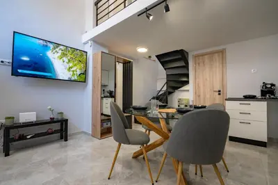 a kitchen and dining room with a table and chairs at LEX & LUX 3-Levels Maisonette in Athens