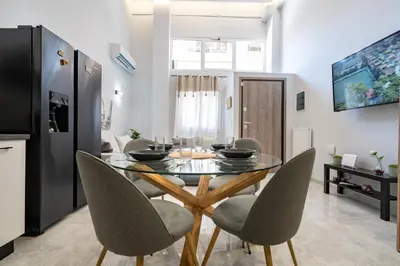 a kitchen and dining room with a glass table and chairs at LEX & LUX 3-Levels Maisonette in Athens