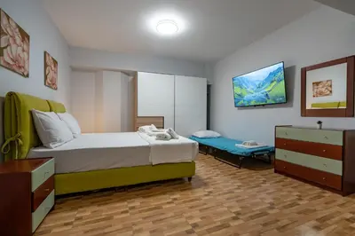 a bedroom with a bed and a bench in it at LEX & LUX 3-Levels Maisonette in Athens