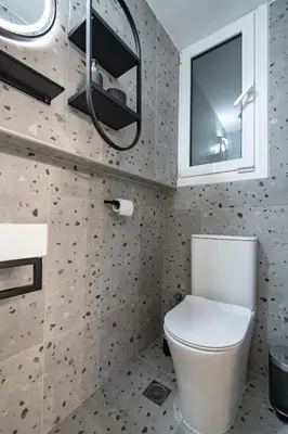 a bathroom with a toilet and a window at LEX & LUX 3-Levels Maisonette in Athens