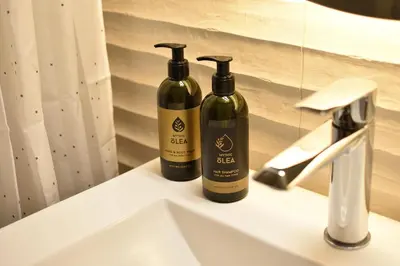 two bottles of wine sitting on a bathroom sink at Philon's City Retreat - Near Athens Center in Athens