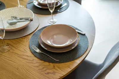 a wooden table with plates and silverware on it at Philon's City Retreat - Near Athens Center in Athens