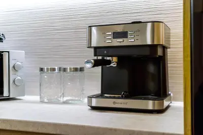 a coffee maker sitting on a counter next to a glass at Philon's City Retreat - Near Athens Center in Athens