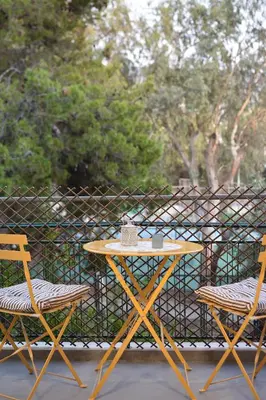 a table and two chairs on a balcony at Philon's City Retreat - Near Athens Center in Athens