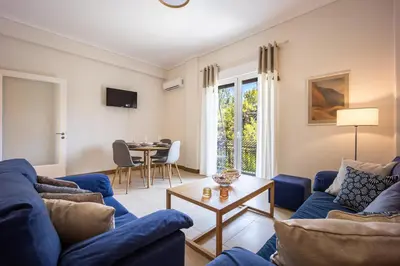 a living room with blue couches and a table at Philon's City Retreat - Near Athens Center in Athens