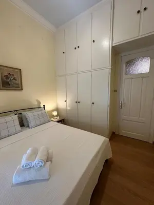 a bedroom with a white bed with towels on it at The Agora Residence in Athens