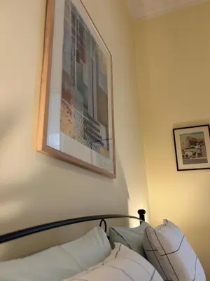 a bedroom with a picture hanging above a bed at The Agora Residence in Athens