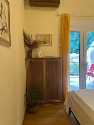 a bedroom with a bed and a door to a patio at The Agora Residence in Athens
