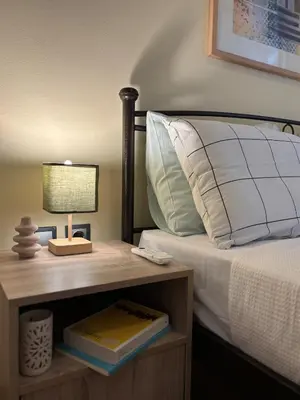 a bedroom with a bed with a table with a lamp at The Agora Residence in Athens
