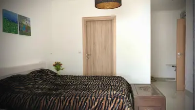 a bedroom with a bed in a room with a door at VillaSophycom in Vari