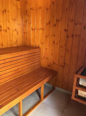 a wooden bench sitting in a sauna at VillaSophycom in Vari