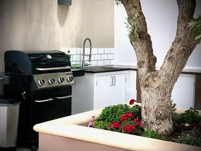 a kitchen with a tree and a sink with flowers at VillaSophycom in Vari