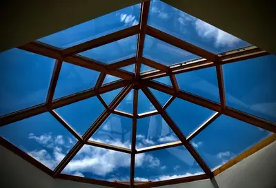 a glass ceiling with a blue sky in the background at VillaSophycom in Vari