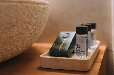 two bottles of hair products sitting on a table at Koukaki Zen Studio in Athens