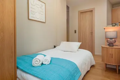 a bedroom with a bed with towels on it at Koukaki Zen Studio in Athens