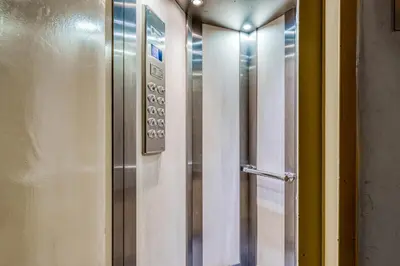 a stainless steel elevator in a room at Koukaki Zen Studio in Athens
