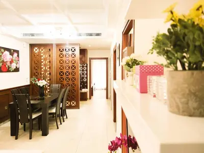 a dining room with a table and chairs and flowers at Oulang Cozy Apartment Athens- Acropolis View Haven in Athens
