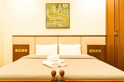 a bedroom with a bed with two towels on it at Oulang Cozy Apartment Athens- Acropolis View Haven in Athens