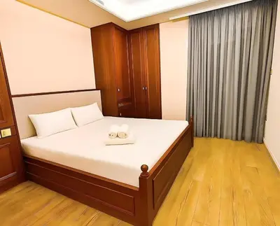 a bedroom with a bed with two candles on it at Oulang Cozy Apartment Athens- Acropolis View Haven in Athens