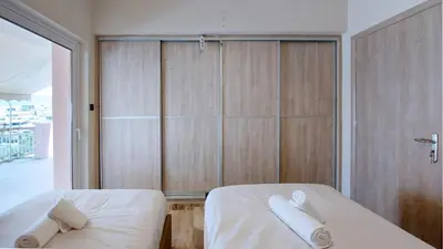 two beds in a room with wooden walls at Modern, Renovated Apartment in Nikaia in Piraeus