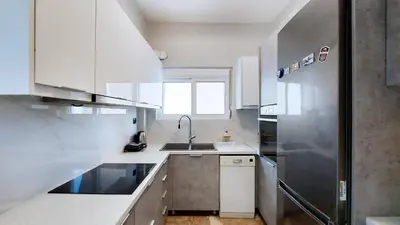 a kitchen with a sink and a refrigerator at Modern, Renovated Apartment in Nikaia in Piraeus