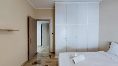 a bedroom with a bed with a towel on it at Modern, Renovated Apartment in Nikaia in Piraeus