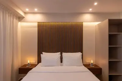 a bedroom with a large bed with two lamps at Ermou Kaliendia Suite in Athens