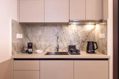 a kitchen with white cabinets and a sink at Ermou Kaliendia Suite in Athens