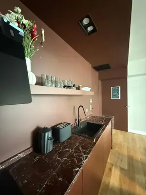 a kitchen with a black counter top and a sink at Syntagma Urban Residences in Athens