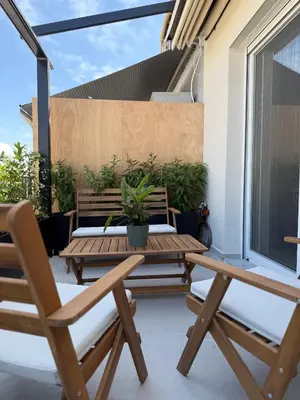 a patio with a wooden table and two chairs at Syntagma Urban Residences in Athens