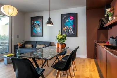 a kitchen and living room with a table and chairs at Syntagma Urban Residences in Athens