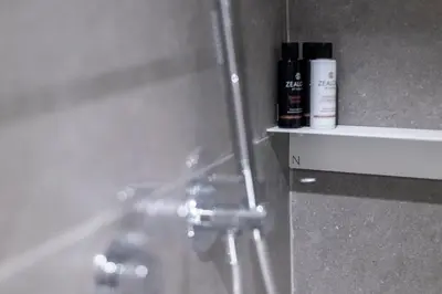 a bathroom with a shower with a bottle of shampoo at Syntagma Urban Residences in Athens