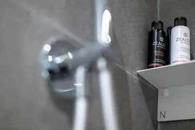 a close up of a bathroom sink with two bottles at Syntagma Urban Residences in Athens