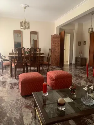 a living room with a dining room table and chairs at Παλαιό Φάληρο Αθηναϊκή Ριβιέρα in Athens