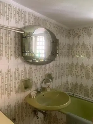 a bathroom with a green sink and a mirror at Παλαιό Φάληρο Αθηναϊκή Ριβιέρα in Athens