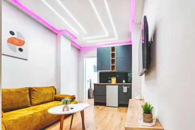 a living room with a yellow couch and a table at Melina's Apartment Neo Psychiko in Athens