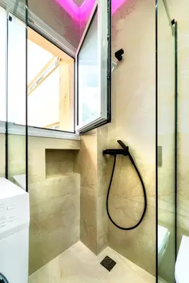 a bathroom with a shower with a glass door at Melina's Apartment Neo Psychiko in Athens