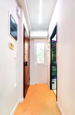 a hallway with a door and a window at Melina's Apartment Neo Psychiko in Athens