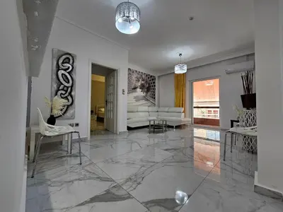 a living room with a large marble floor at SantaRoza Luxury Apartment in Piraeus