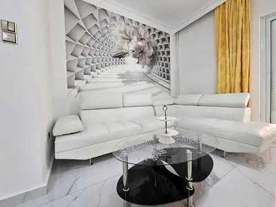 a living room with a white couch and a glass table at SantaRoza Luxury Apartment in Piraeus