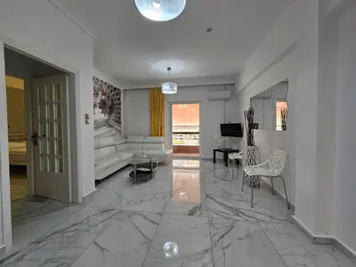 a living room with a couch and a table at SantaRoza Luxury Apartment in Piraeus