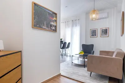 a living room with a couch and a table at Koukaki 2BR Apt with Balcony, Walk to Acropolis in Athens