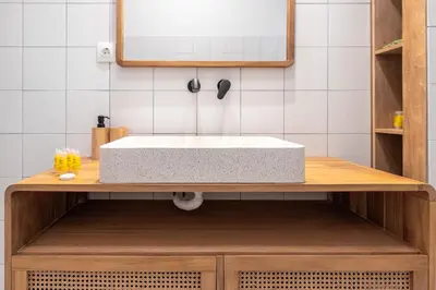 a bathroom with a sink on a wooden vanity at Koukaki 2BR Apt with Balcony, Walk to Acropolis in Athens