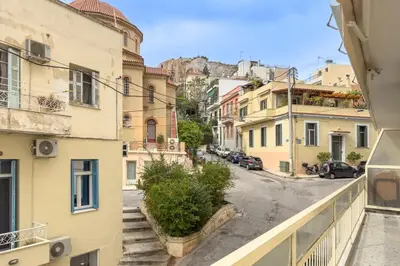 a view from a balcony of a street with buildings at Koukaki 2BR Apt with Balcony, Walk to Acropolis in Athens
