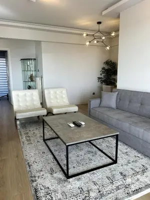 a living room with a couch and a coffee table at Altitude 5 Penthouse Elliniko in Athens