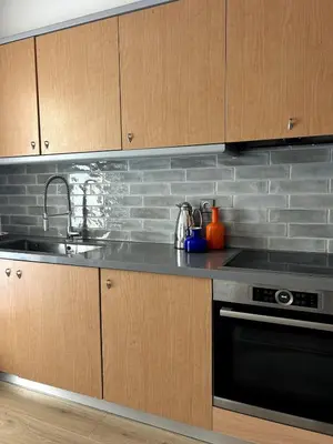 a kitchen with a sink and a stove at Altitude 5 Penthouse Elliniko in Athens