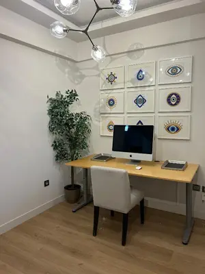 a desk with a computer and a chair in a room at Altitude 5 Penthouse Elliniko in Athens